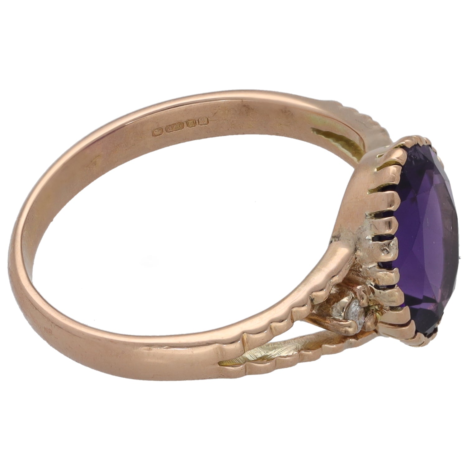 Rose gold tone ring band with dark purple oval stone and scalloped setting detail