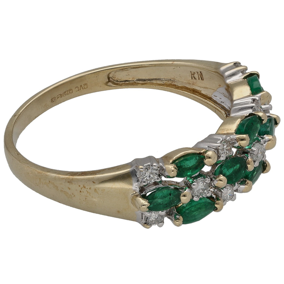 Gold half eternity ring with emerald green stones and round diamond cluster detail