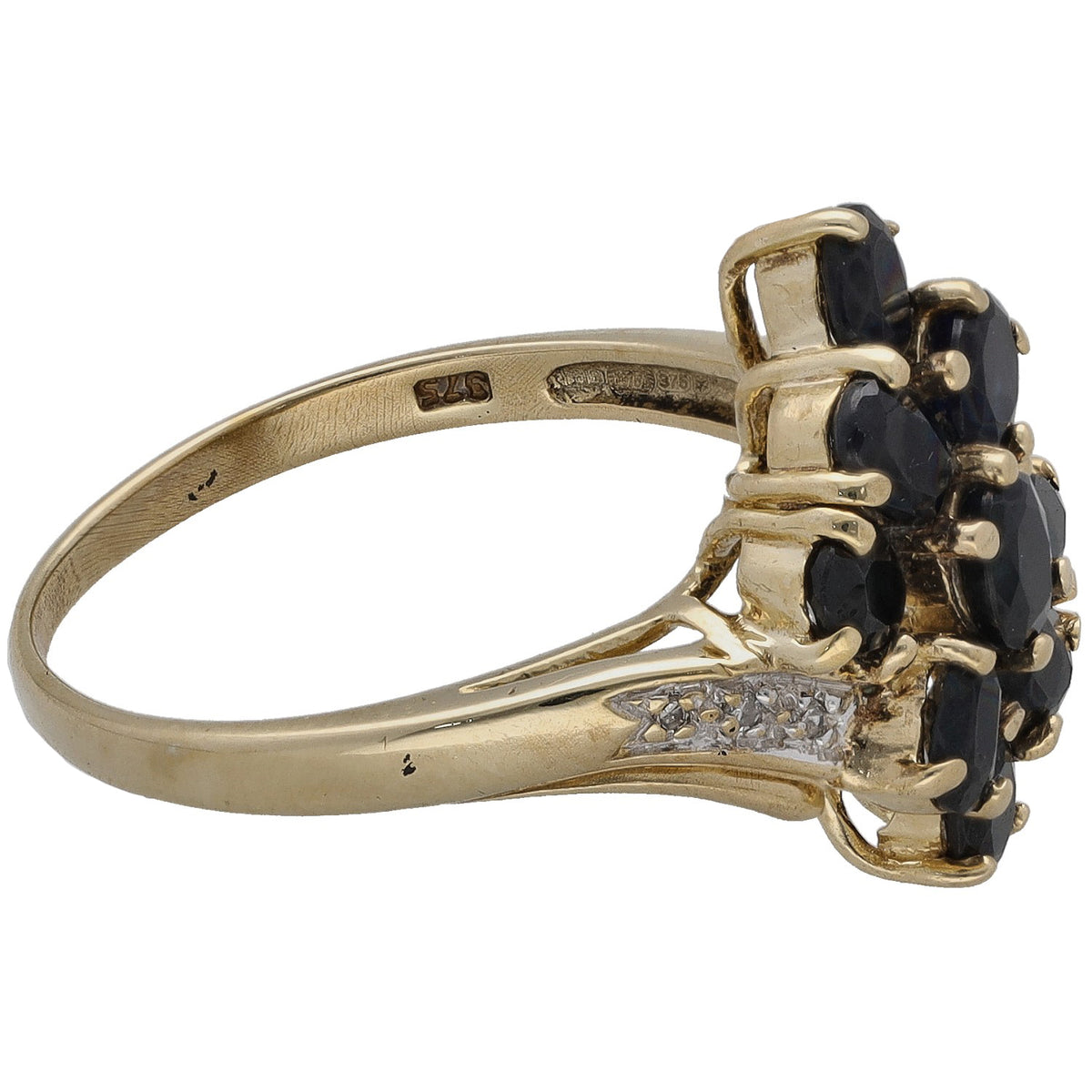 Gold ring side view with bezel-set dark sapphire stones and diamond accents