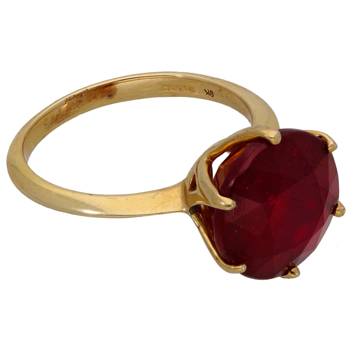 Gold single-stone ring with round dark red gemstone and prong setting