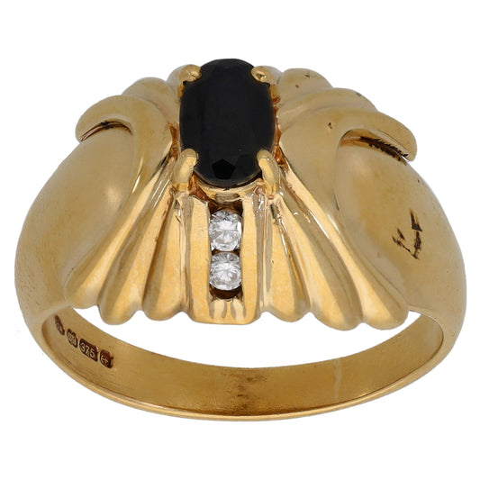 9ct gold ring with oval dark sapphire and three round diamonds in a row on top
