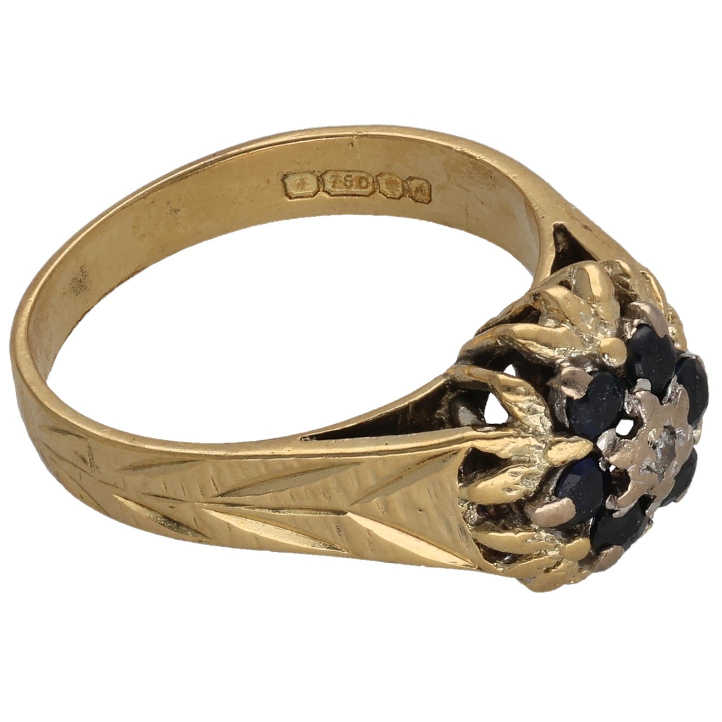 Gold ring featuring dark stone cluster setting and engraved inner band details