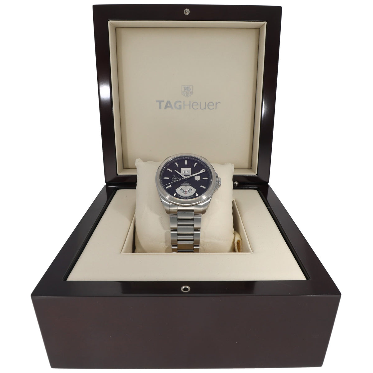 Tag Heuer Carrera WAV5113 watch in box, stainless steel bracelet and dark dial on pillow.