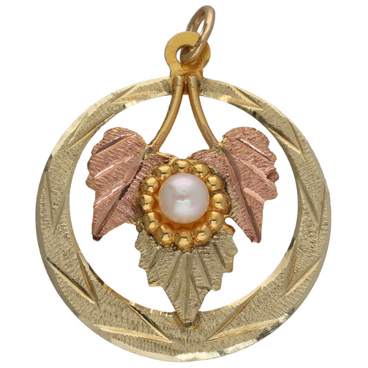 Bicolour gold pendant with cultured pearl, circular frame and leaf-like accents
