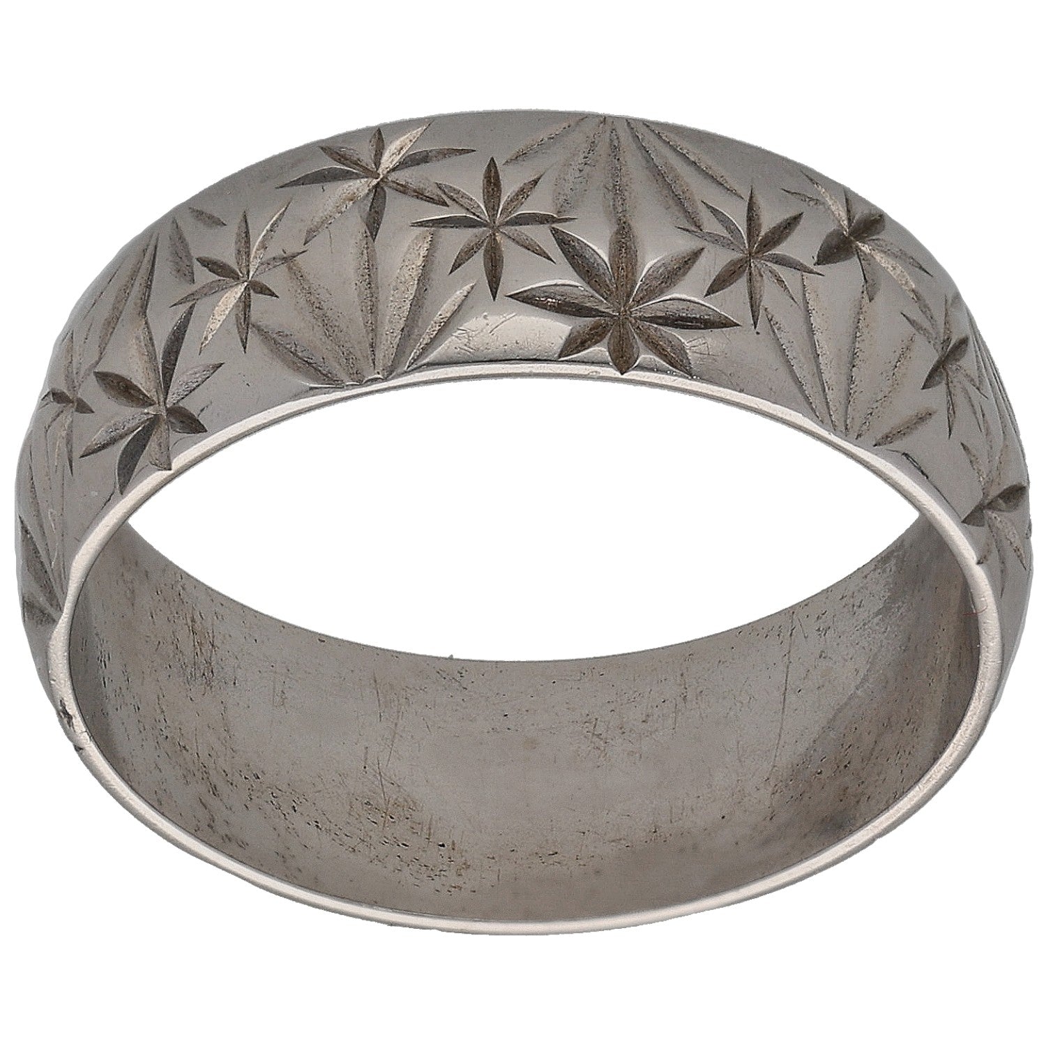 White gold wedding ring with carved star floral pattern across the band