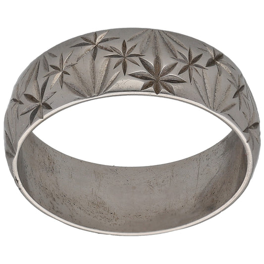 White gold wedding ring with carved star floral pattern across the band