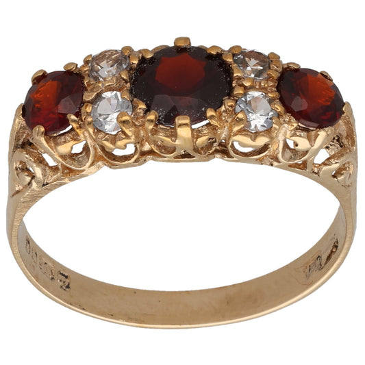 Gold cocktail ring with red garnet-style stones and clear imitation crystals, ornate setting