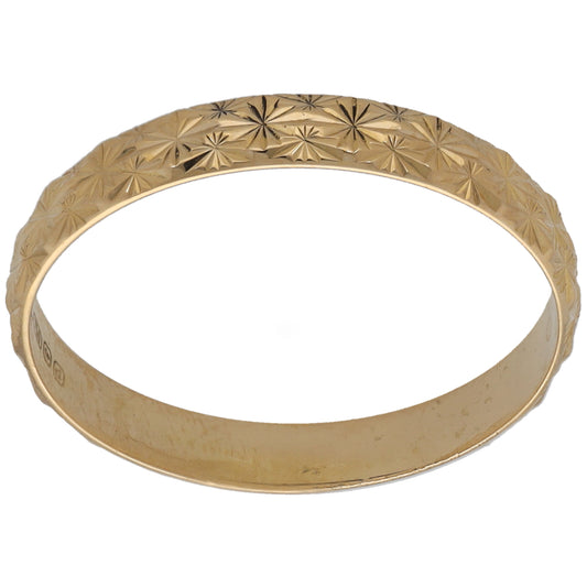 Yellow gold wedding ring with raised geometric diamond and star pattern, slim band