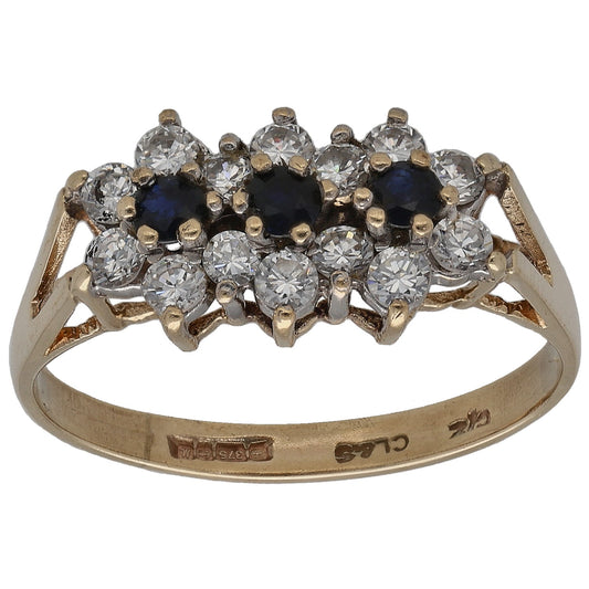 Gold dress ring with cluster of dark blue and clear crystal stones