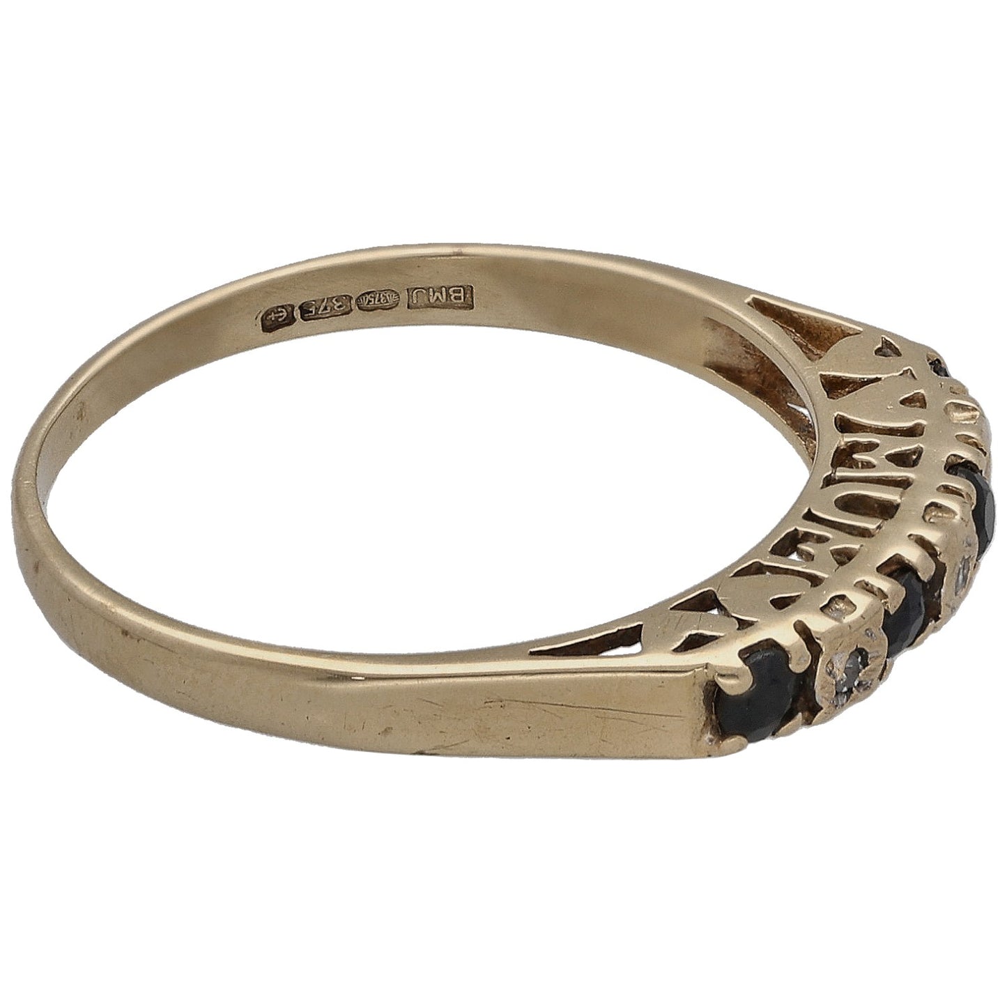 Gold half eternity ring side view with dark stones and round diamond accents
