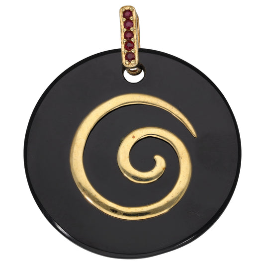 Gold tone pendant with black onyx round disc, gold swirl, and ruby red stone bail