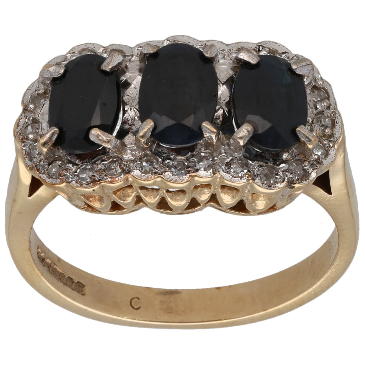 Gold dress ring with three dark oval gemstones and diamond-like side settings