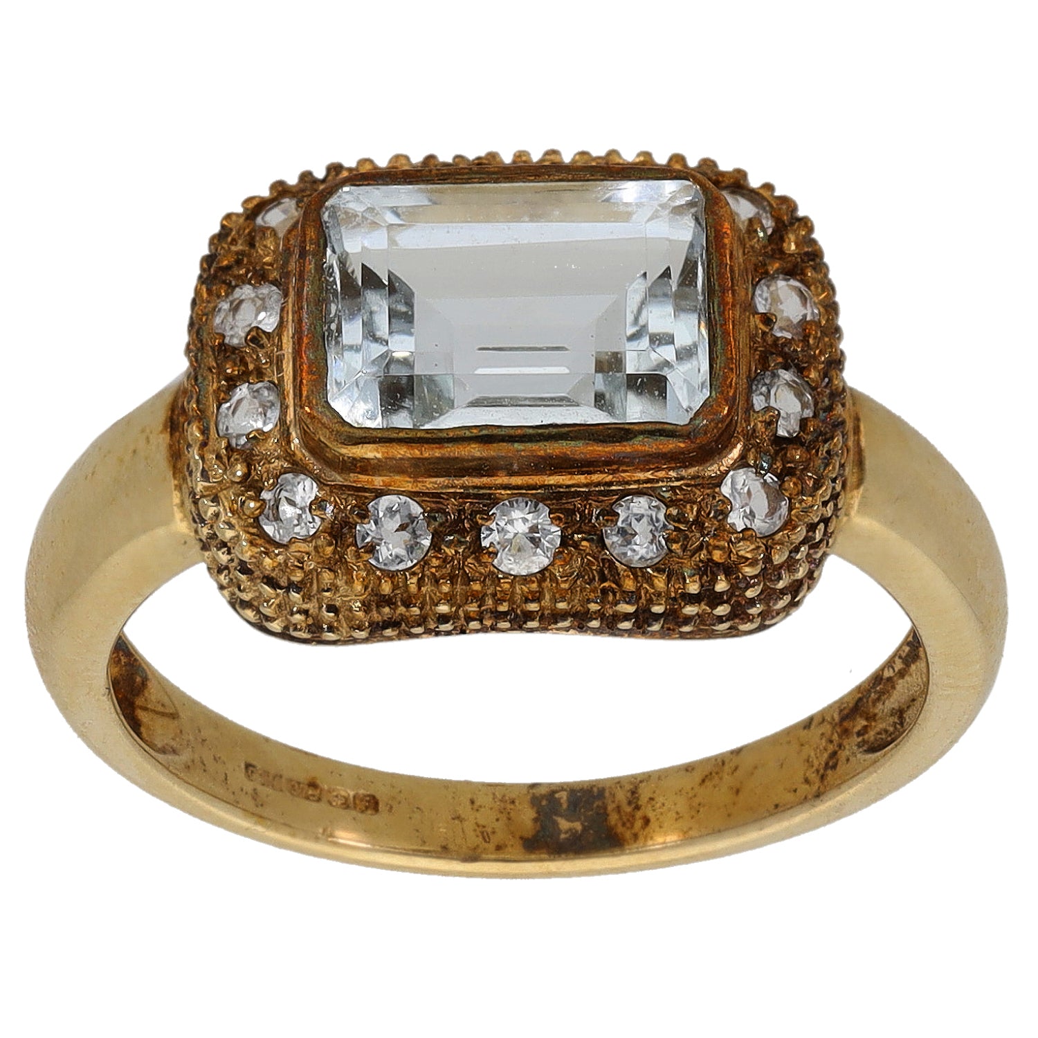 Gold cocktail ring with large rectangular clear center stone and round rhinestone accents