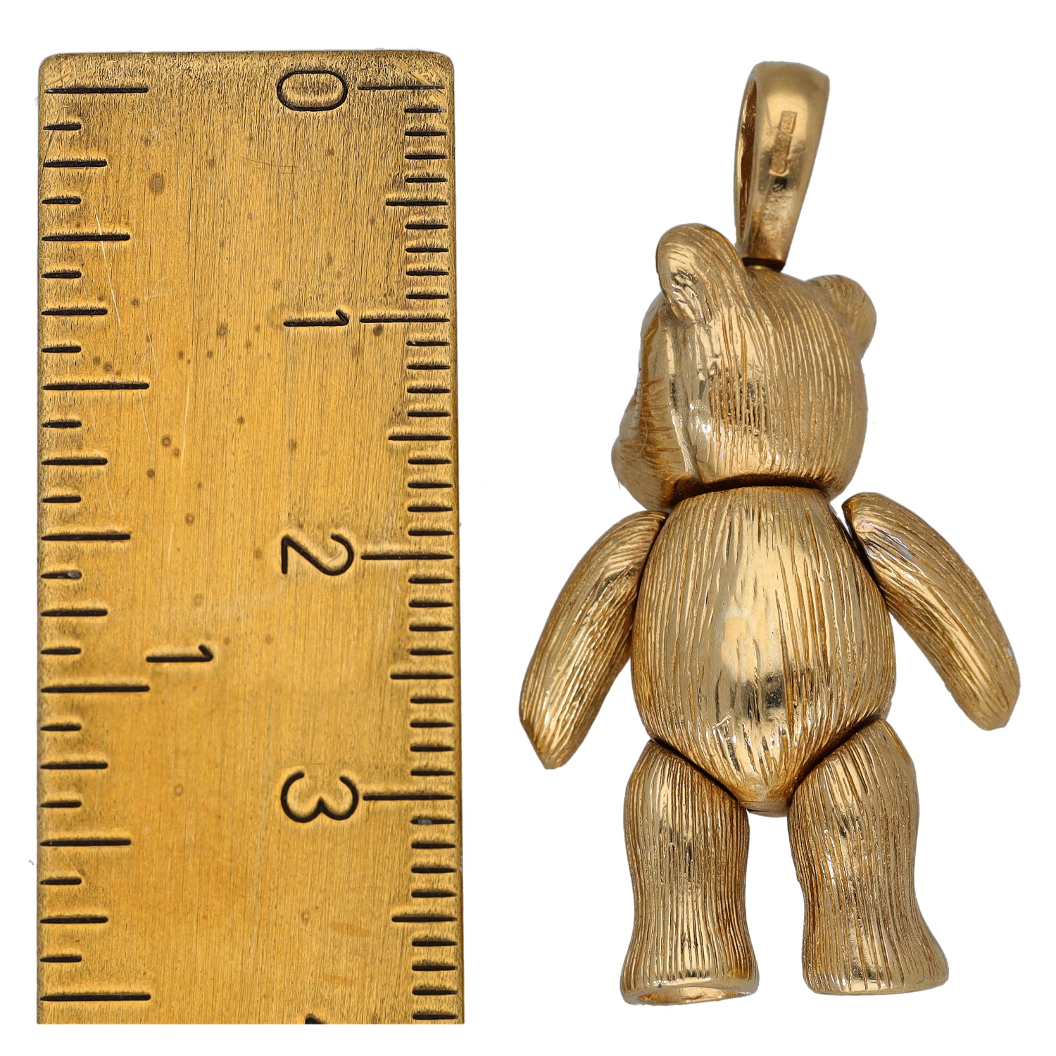 Gold-tone character pendant from side view, bear-clown figure with blue eyes.