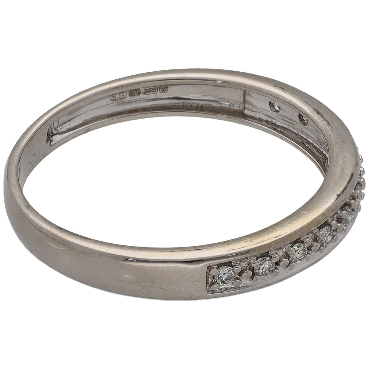White gold half eternity ring with round diamonds inset on one side, hallmarked band