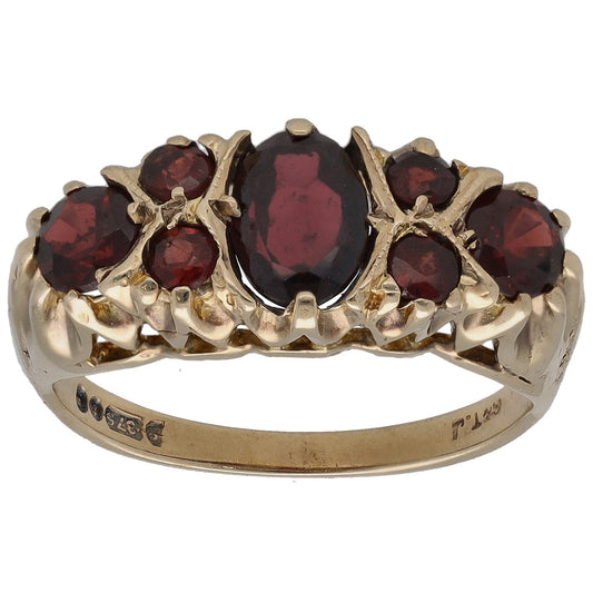 Gold garnet cocktail ring with five marquise-style burgundy stones and prong settings