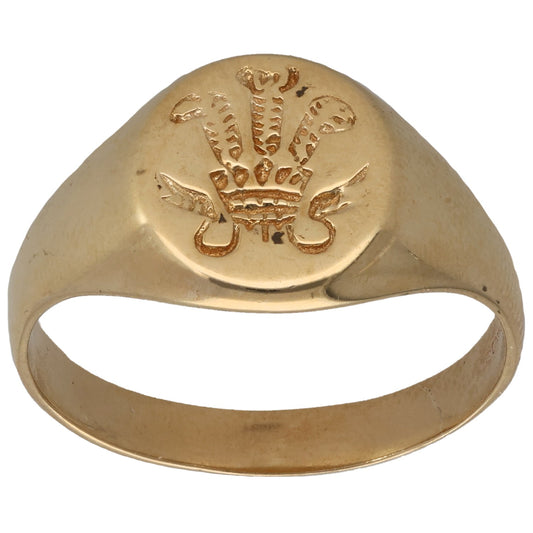 Gold-tone signet ring with engraved emblem on front face