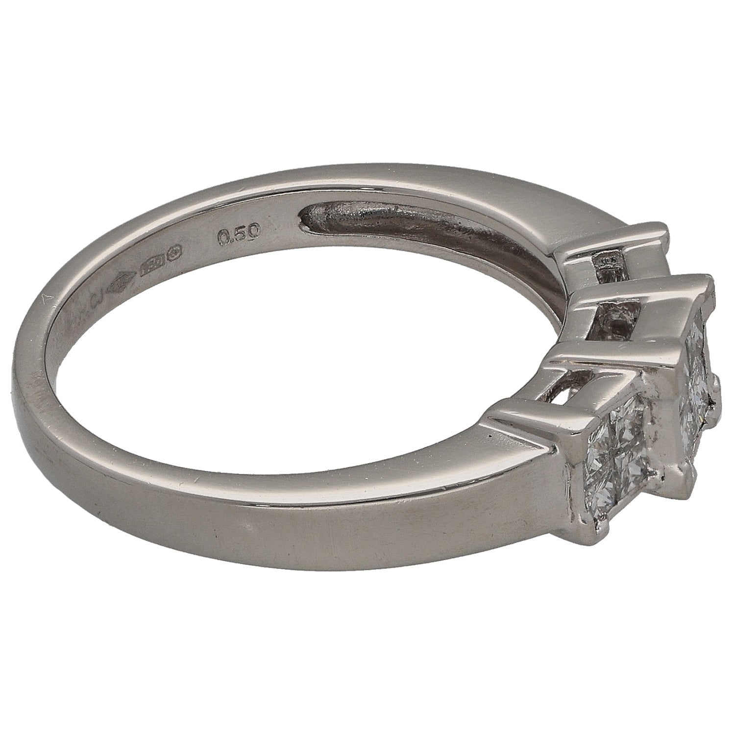 Platinum ring with square diamond cluster and setting prongs, side profile view.