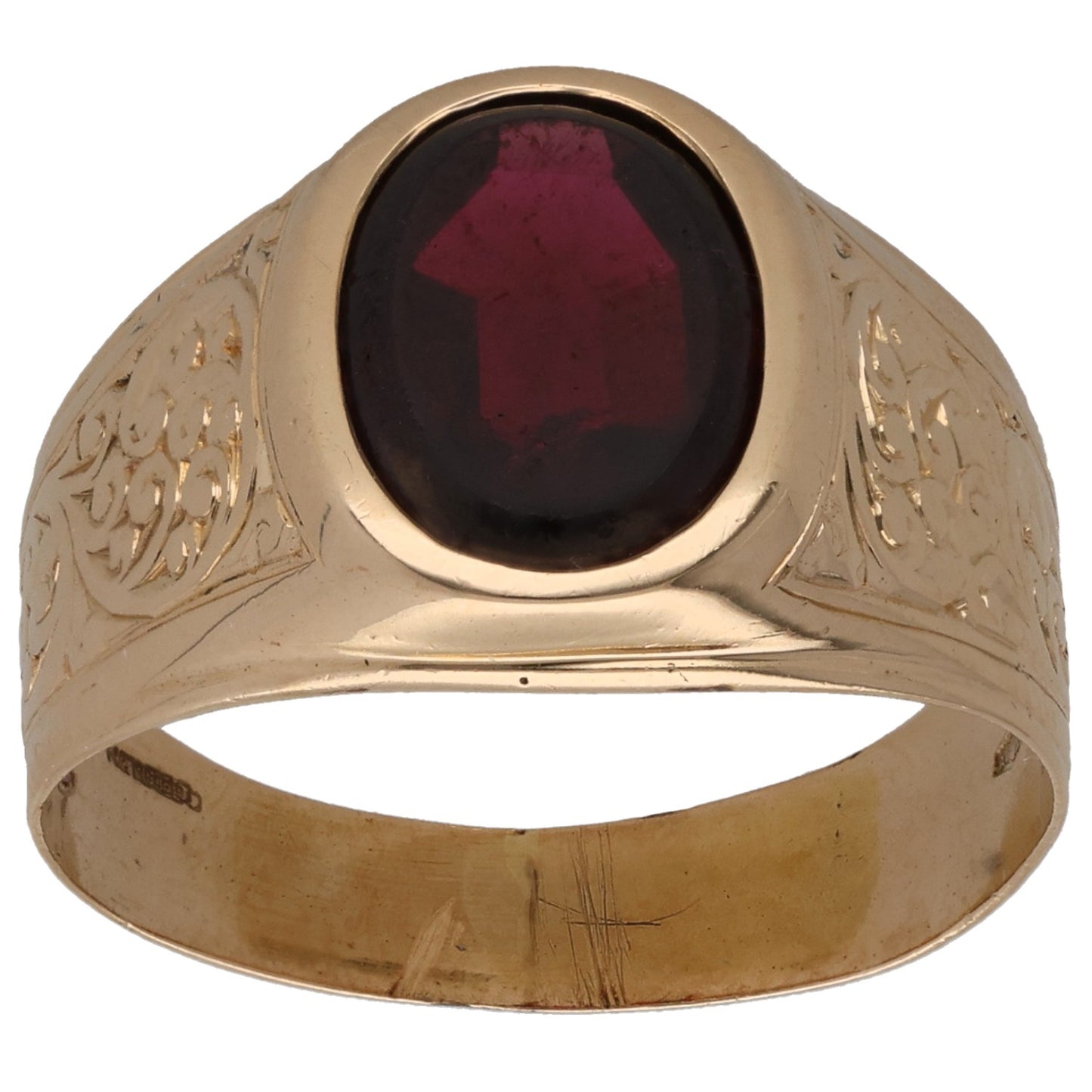 Gold signet ring with maroon faceted oval gemstone and engraved side scrollwork