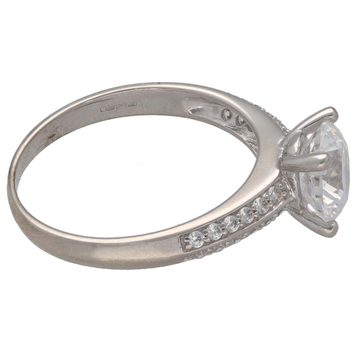 White gold ring with round cz center stone and accent stones along the band