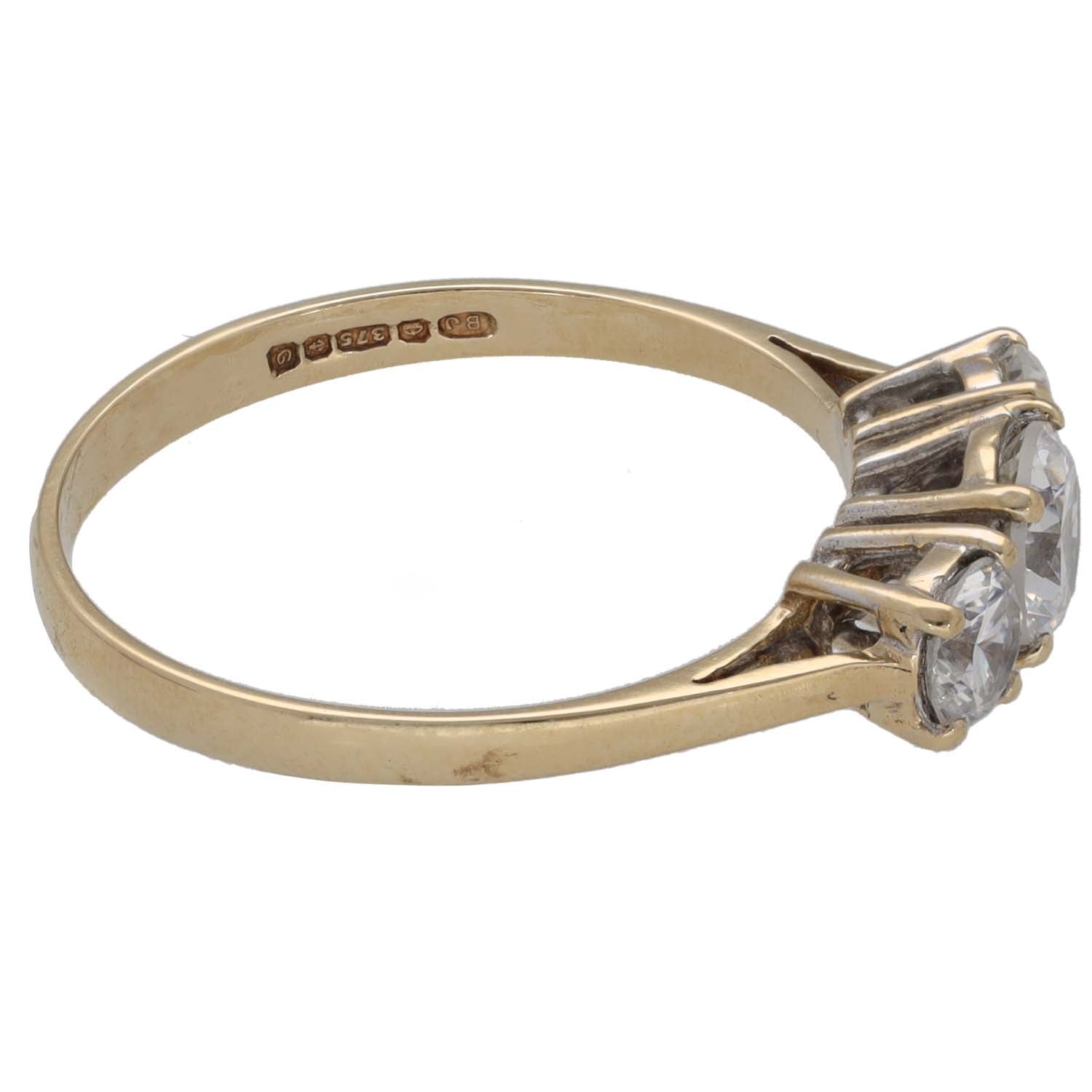 Gold-tone three-stone CZ ring side view with three round clear stones and raised setting
