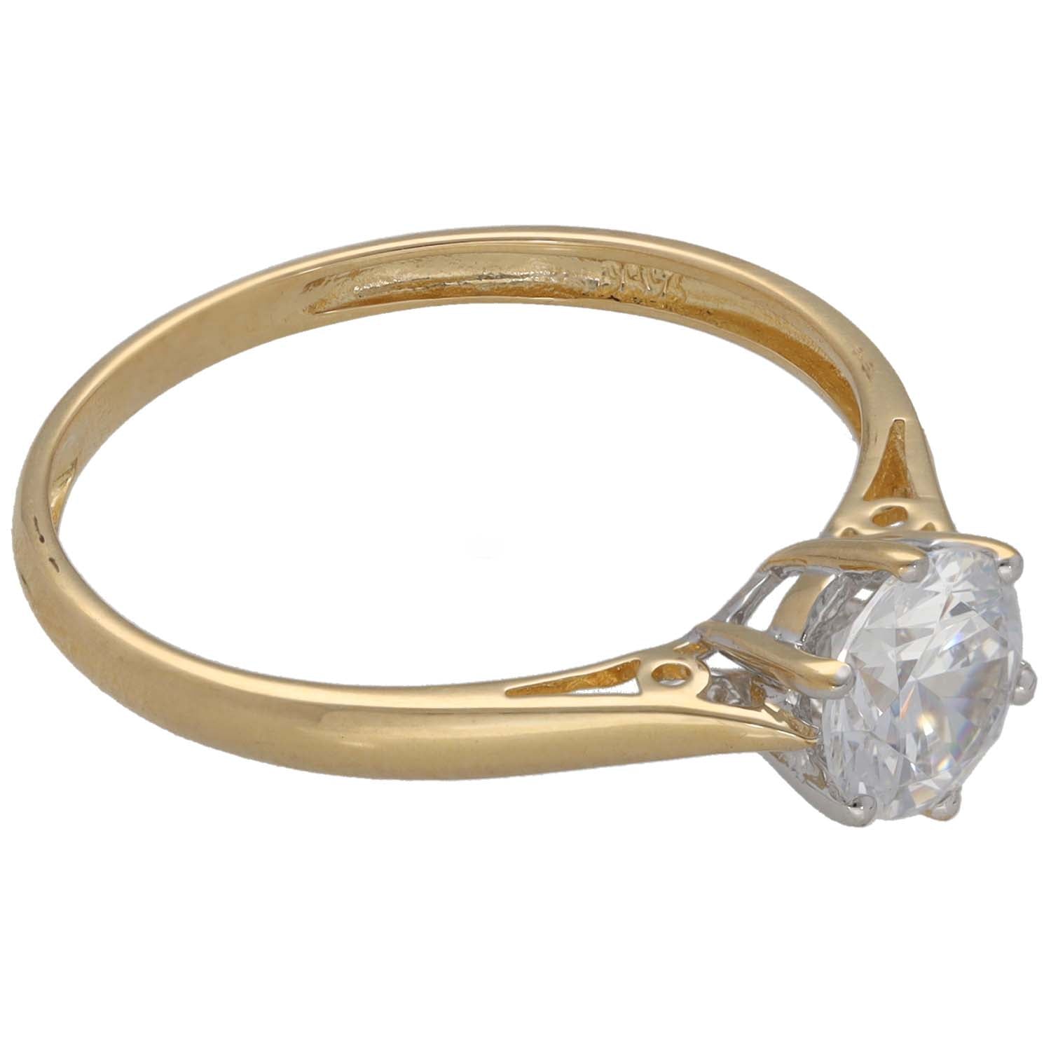 Gold ring with round clear cubic zirconia stone in side view setting