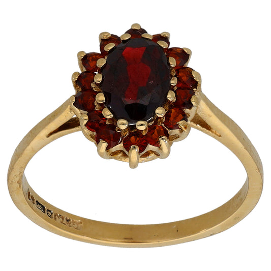 Gold garnet cocktail ring with oval red center stone and round red halo, size M