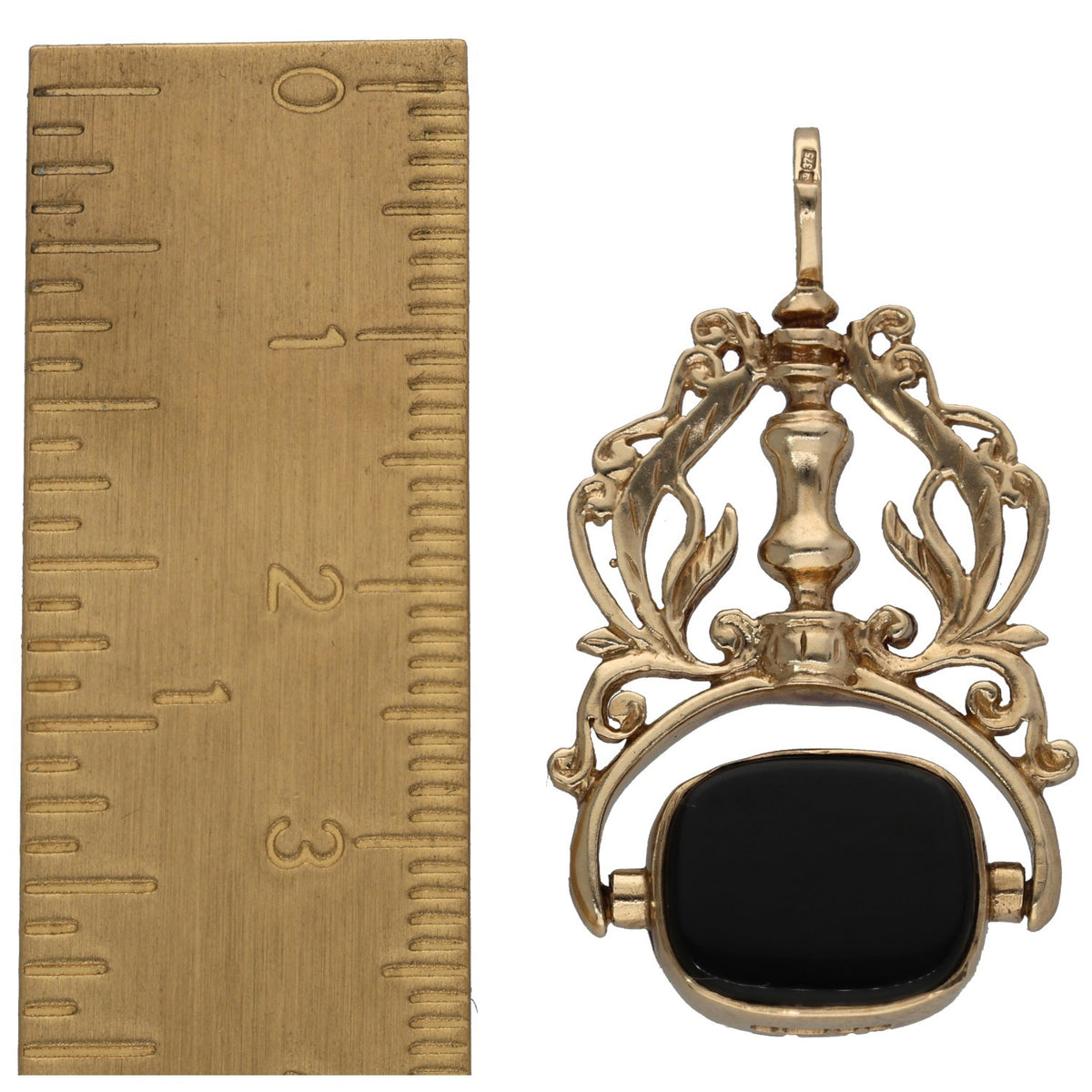 Gold filigree fob pendant with dark oval onyx-style inset and top bail