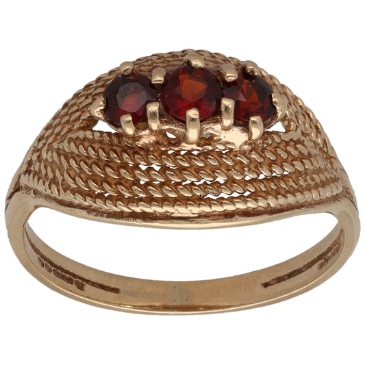9ct gold three-stone garnet ring with textured band and red gemstone settings