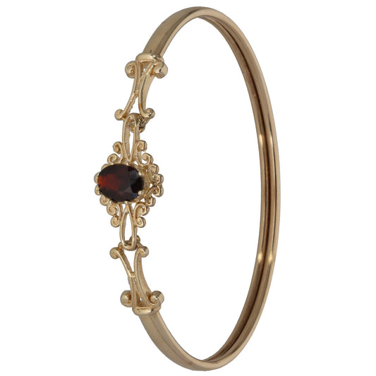 9ct gold garnet hinged bangle with ornate dark red stone and clasp detail