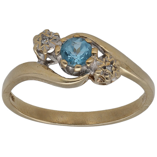 Gold three-stone ring with oval blue topaz and round diamonds in floral settings