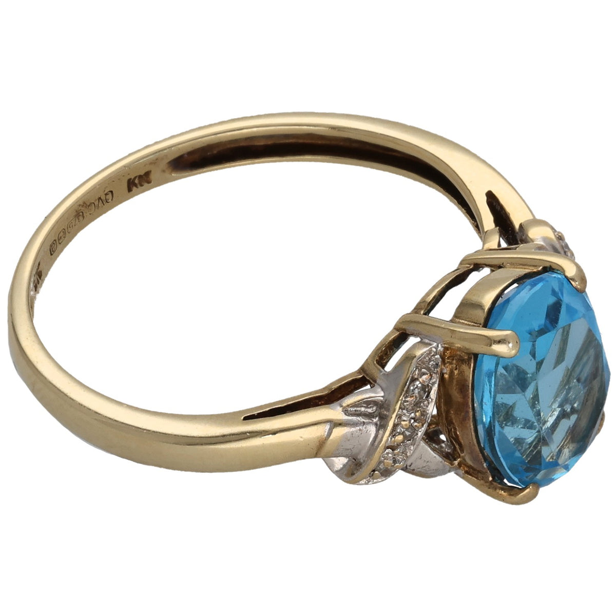 Gold ring side view with prongs holding an oval blue topaz, small diamond detail