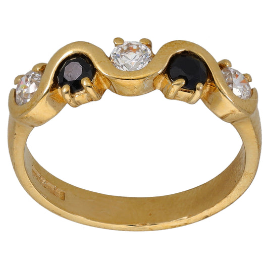 Gold ring with three bezel-set stones: clear center and dark side stones