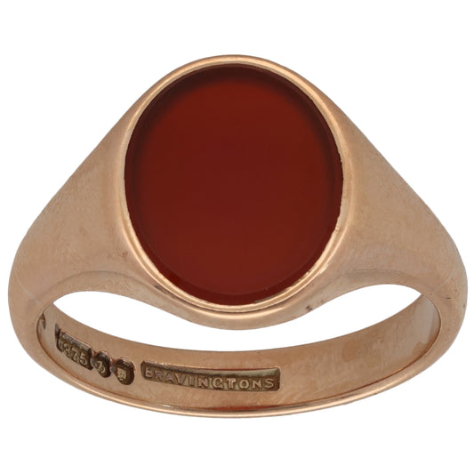 Gold signet ring with oval red carnelian stone and slim plain band