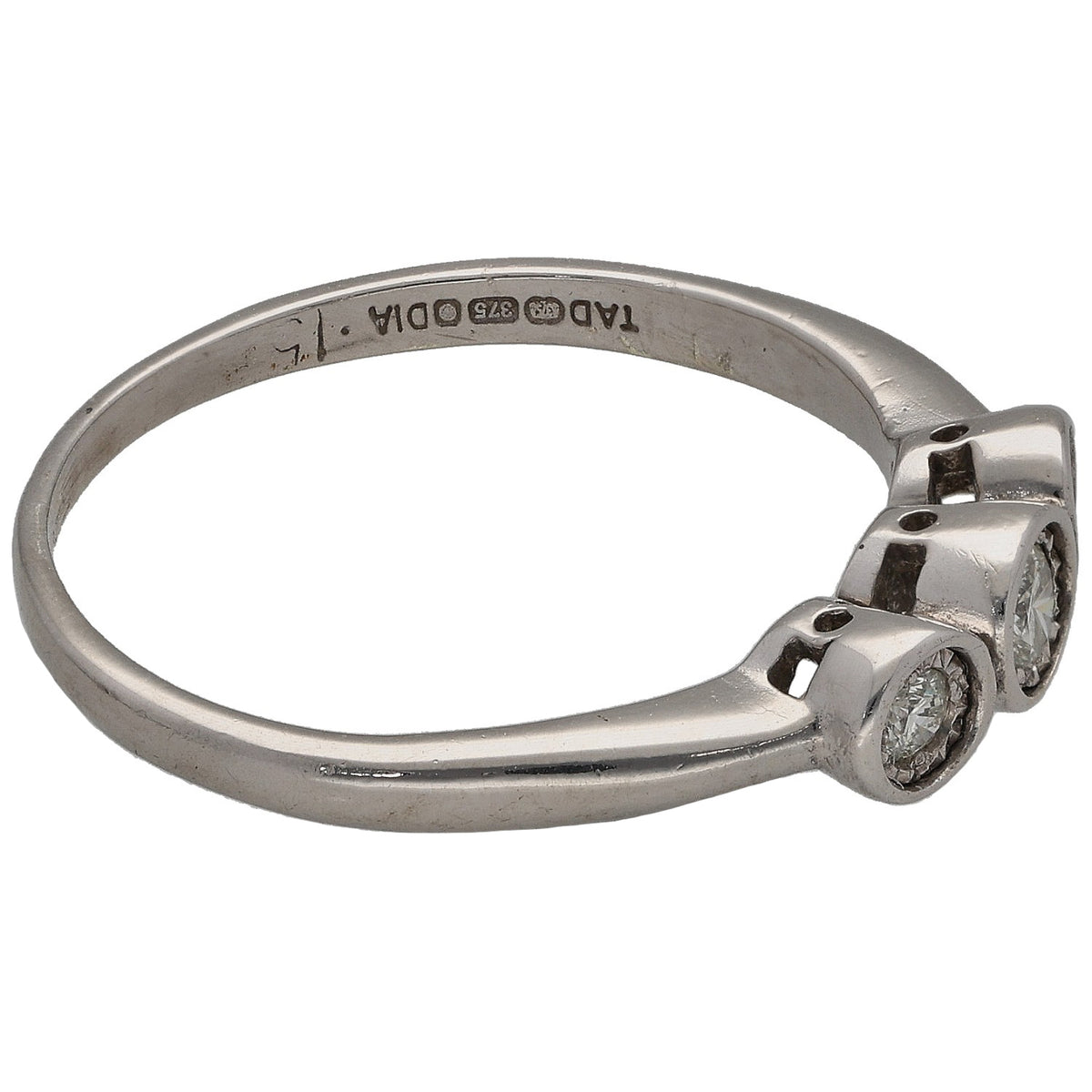 White gold three-stone ring side view with round diamond bezel setting
