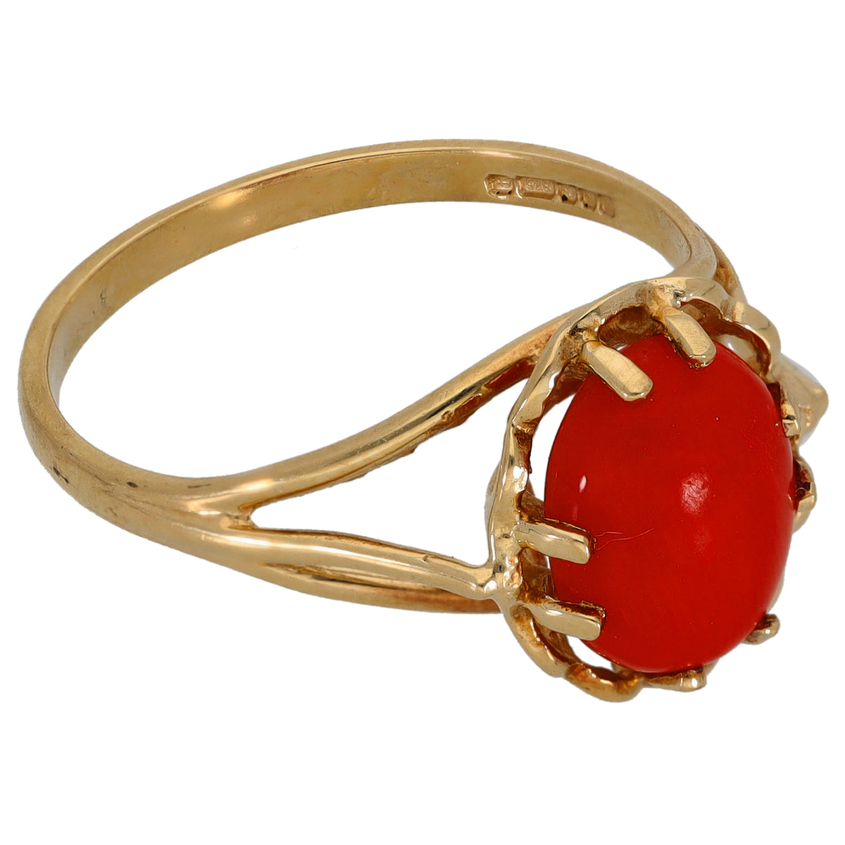 Gold coral ring side view with red oval stone in scalloped claw setting