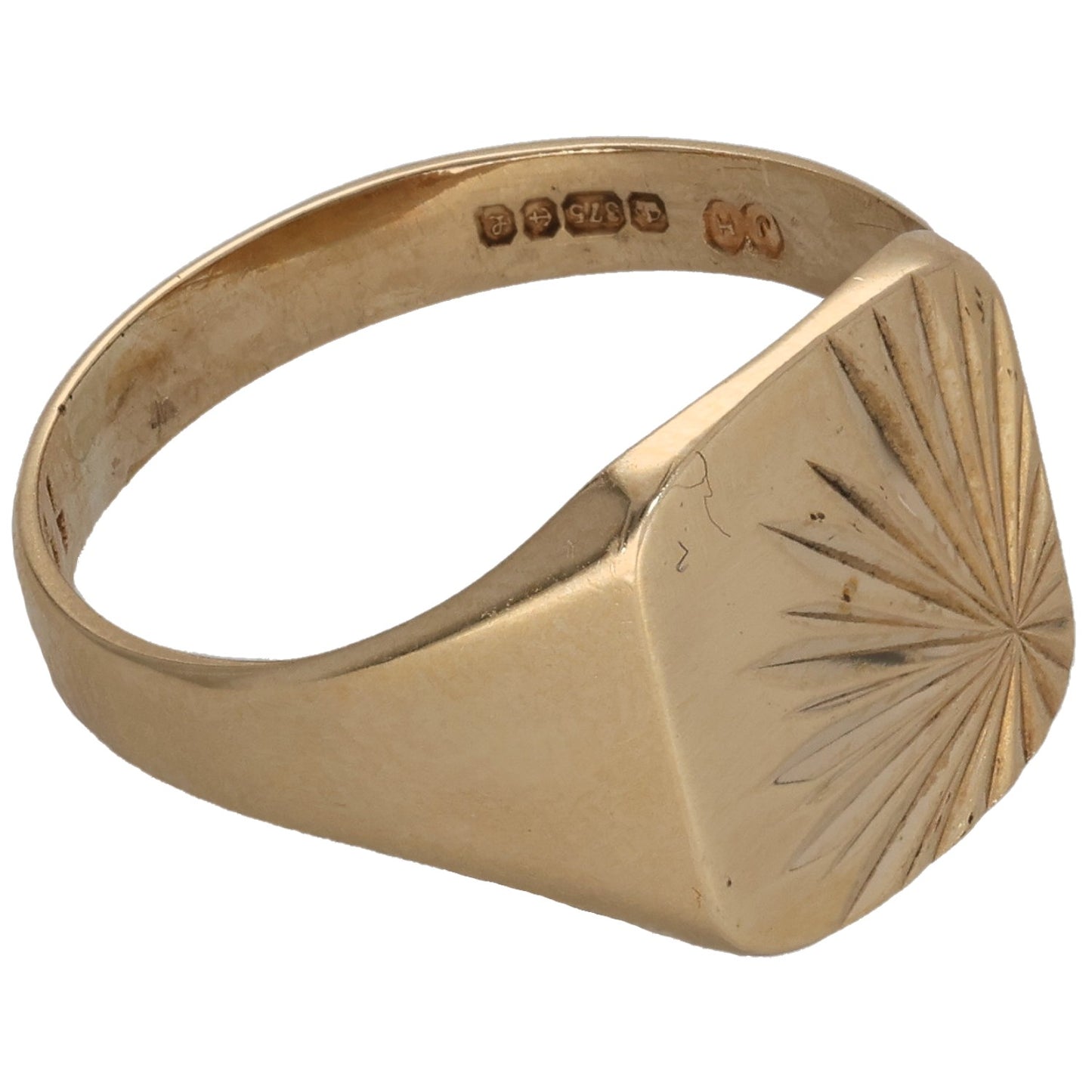 Gold signet ring side view, faceted sunburst pattern and hallmark inside band