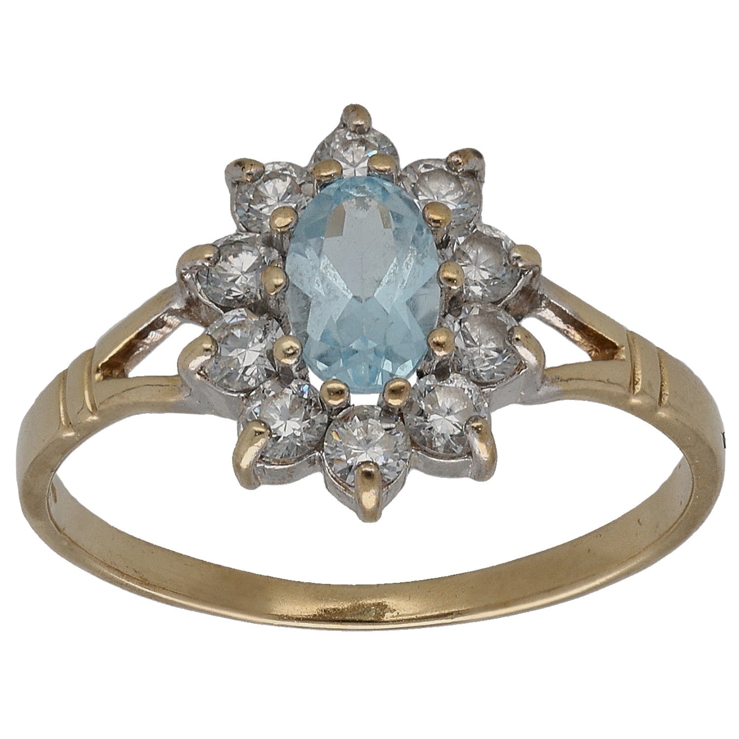 Gold cocktail ring with blue topaz center and sparkling clear CZ cluster halo