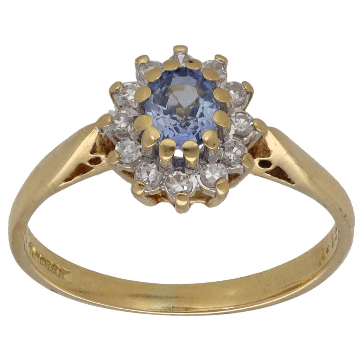 Gold cocktail ring with oval blue sapphire center and diamond halo