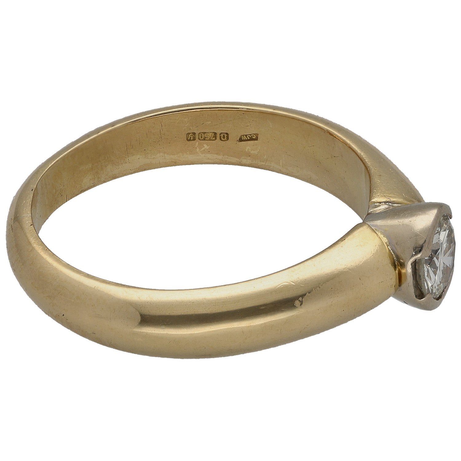 Gold solitaire ring side view with round diamond in prong setting, stamped inner band