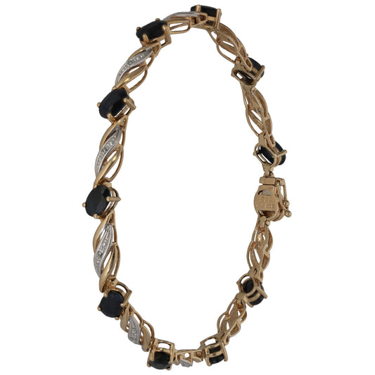 Bicolour gold tennis bracelet with dark sapphire-style stones, diamond accents, clasp end