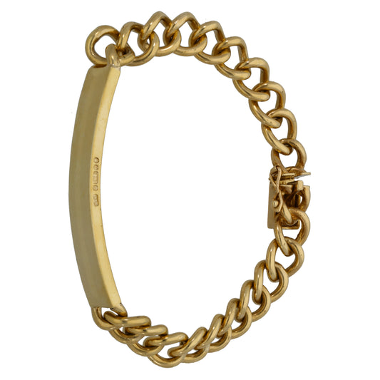 Gold ID bracelet with large curb links, flat ID plate, and side clasp