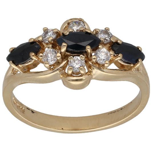 Gold cocktail ring with dark oval center stone and clear round CZ accents