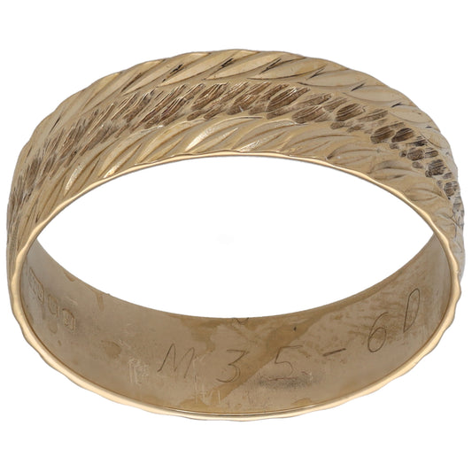 Gold patterned wedding ring with textured leaf pattern, polished band.