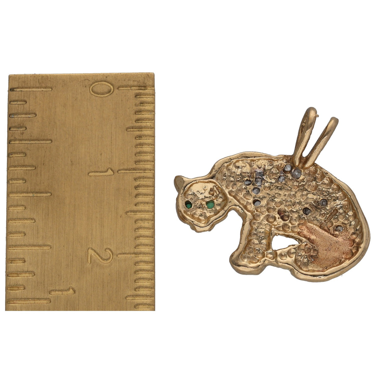 Gold cat-shaped pendant side view with emerald eyes and diamond-textured surface