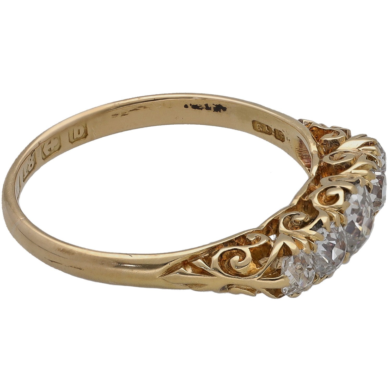 Yellow gold diamond ring with three round stones and decorative side setting.