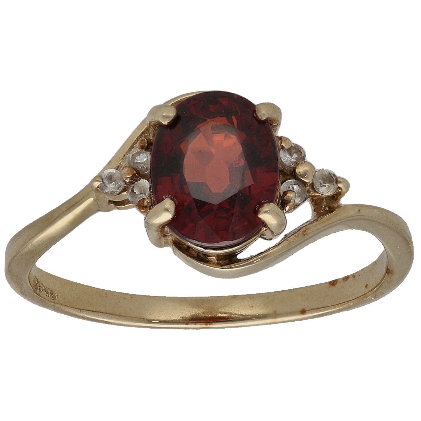 Gold cocktail ring with large red garnet-style faceted center stone and side accents