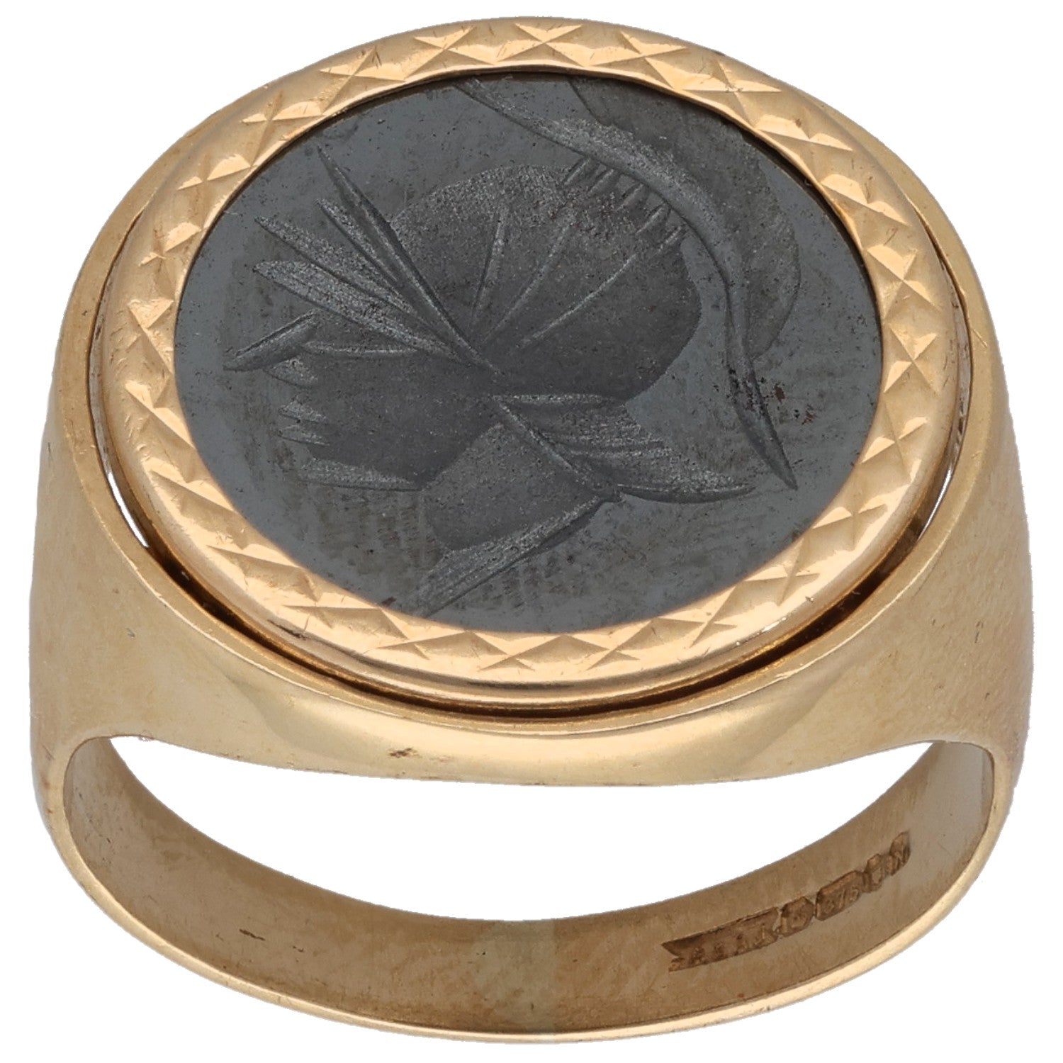 Gold oval signet ring with dark leaf-pattern stone and faceted bezel
