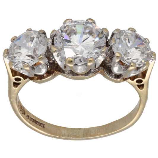 9ct gold three-stone CZ ring with three round clear stones on a slim yellow band