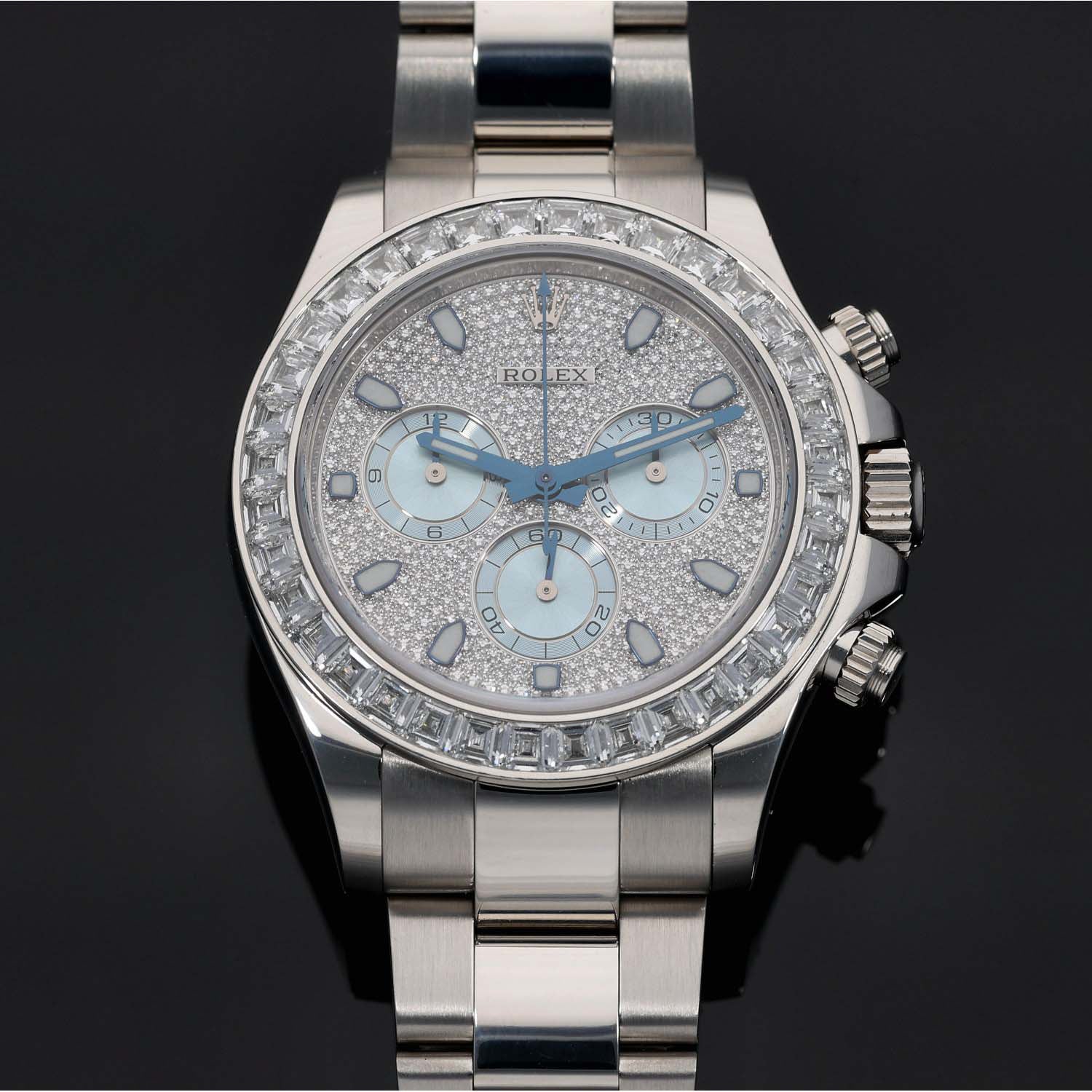 Platinum Rolex Daytona 116576TBR chronograph watch close-up, light blue dial, diamond bezel, steel bracelet